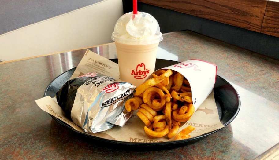 sandwich, fries and shake on a tray in a restaurant