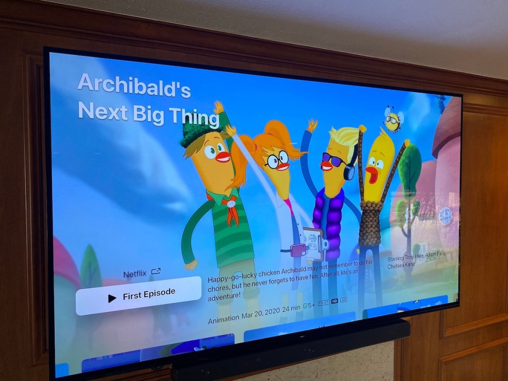 flat screen tv on wall with colorful cartoon on screen