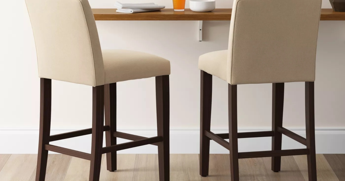 barstools pulled up to wooden bar shelf