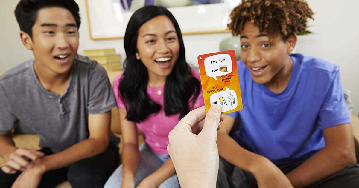 kids sitting around playing a card game