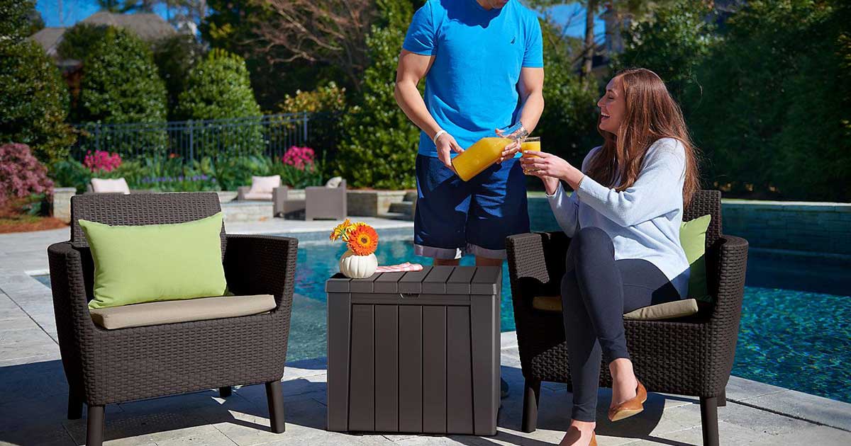 couple on a pool deck with chairs and a storage box