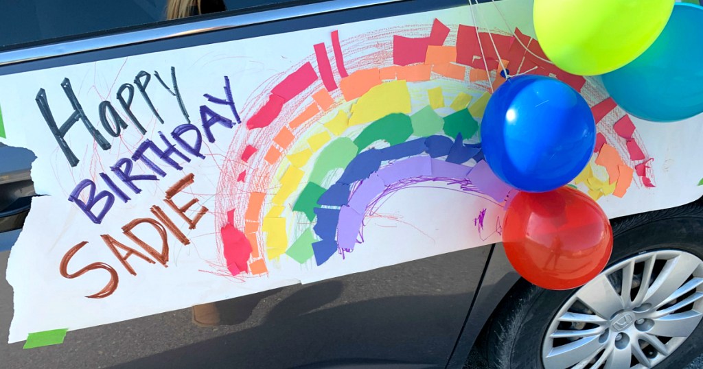 birthday sign on side of car with rainbow