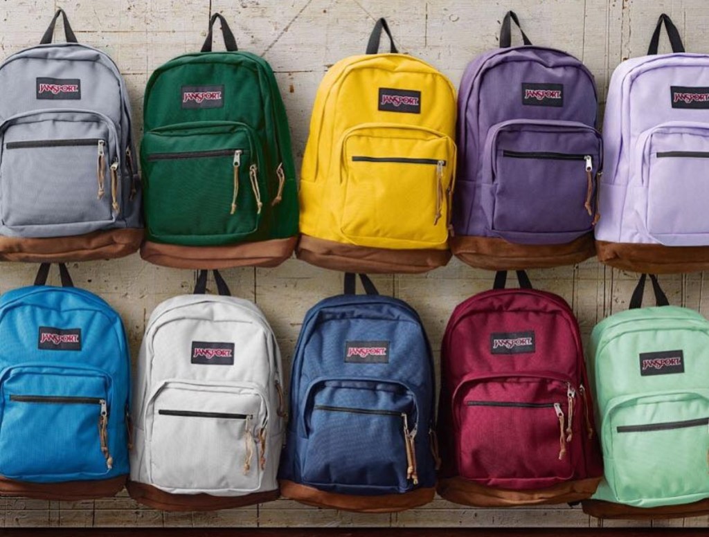 Jansport backpacks hanging on a wall