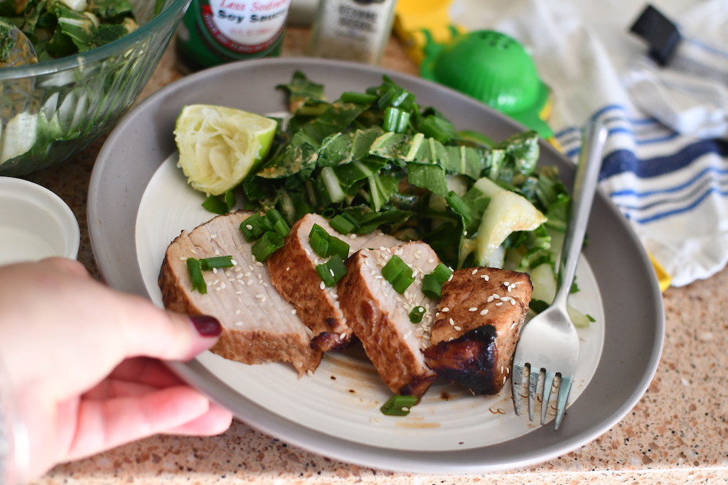 holding plate wih pork loin and salad 