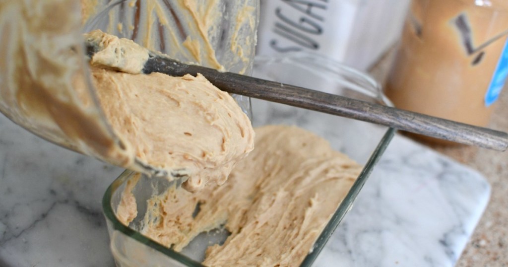 pouring peanut butter bread batter into loaf pan