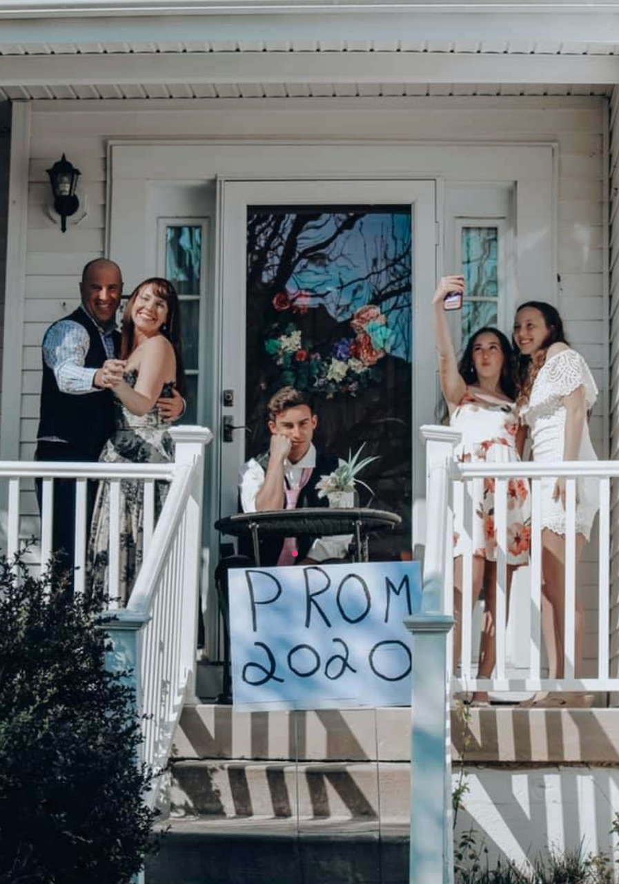 people on front porch dressed up with promo 2020 sign