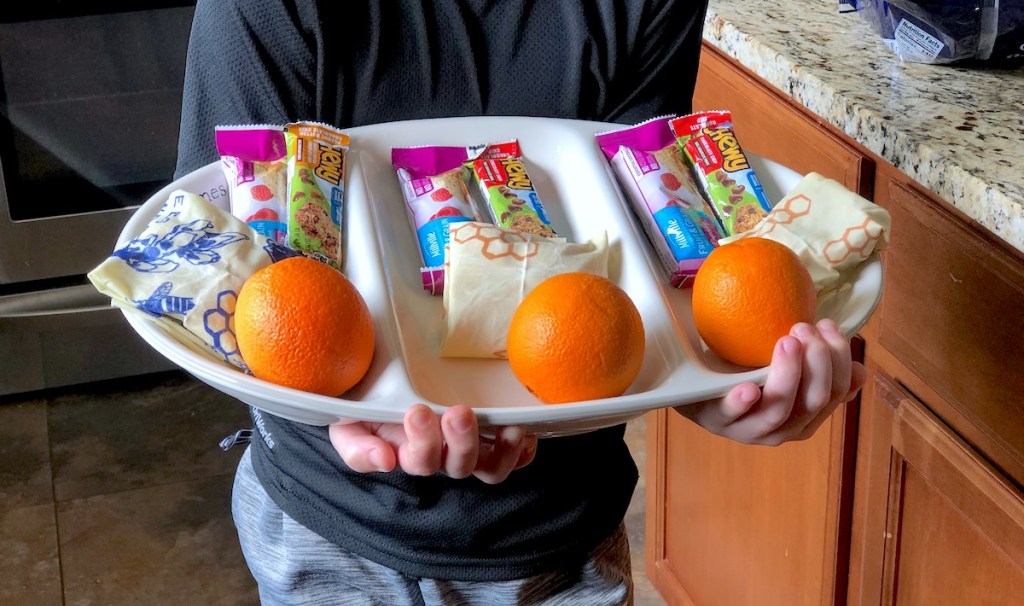 boy holding a tray of snacks