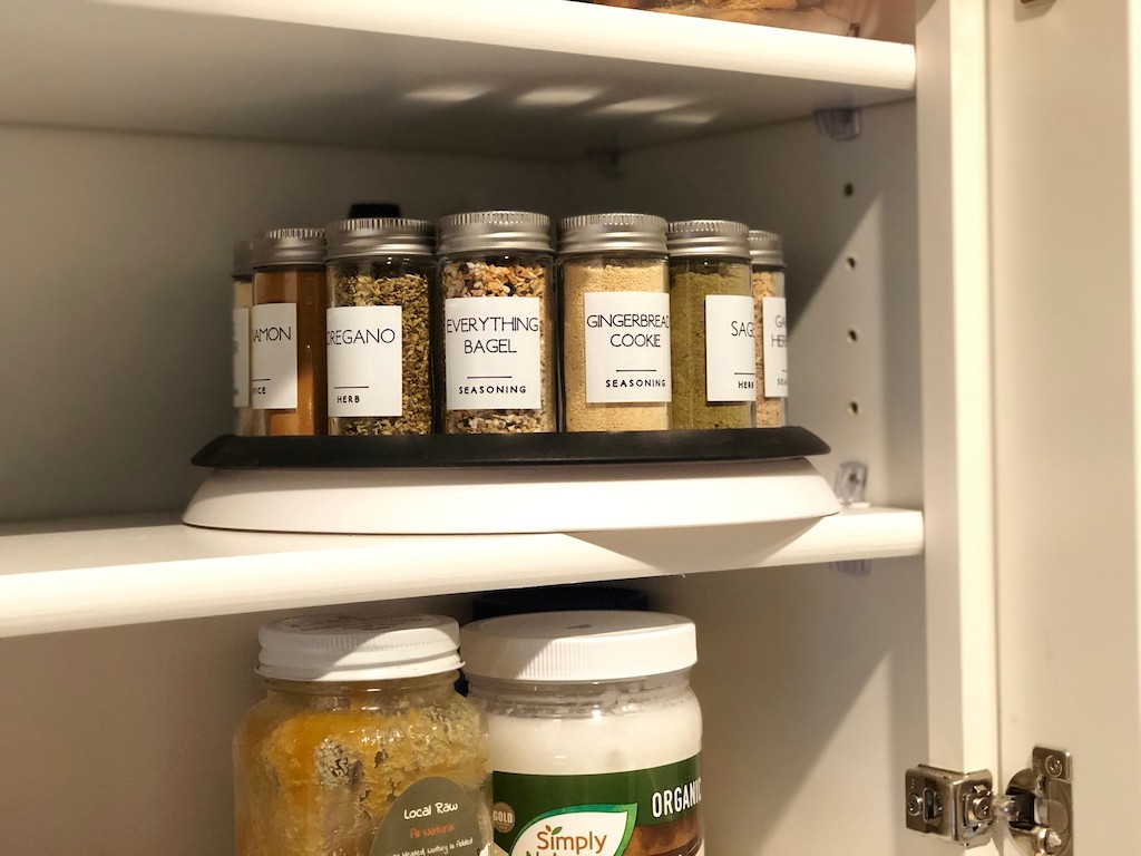 spices on lazy susan in cabinet on shelf