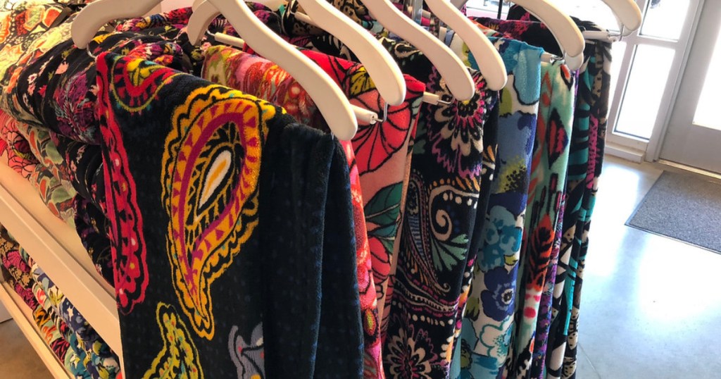 vera bradley printed throw blankets hanging on store rack