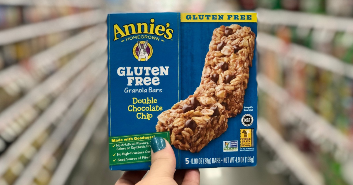 woman hand holding blue box of Annie's Gluten Free Chewy Granola Bars Double Chocolate Chip Bars