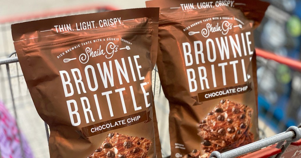two brown bags of brownie brittle in child area of shopping cart