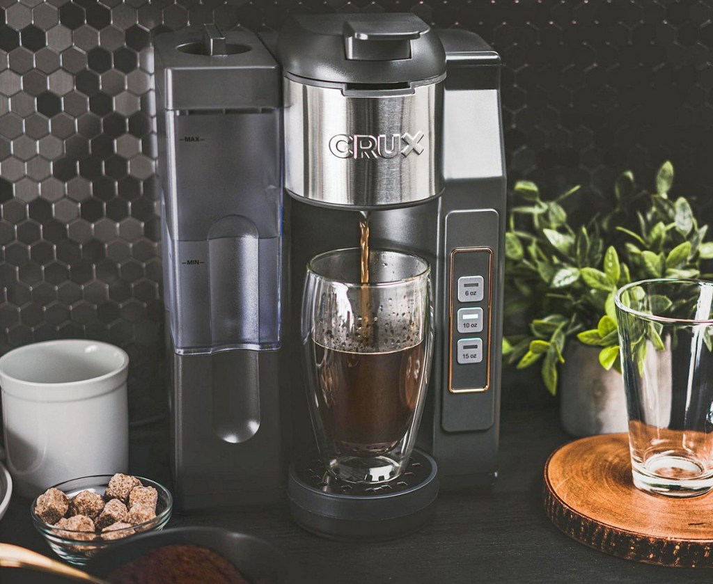 black coffee maker brewing into a glass cup