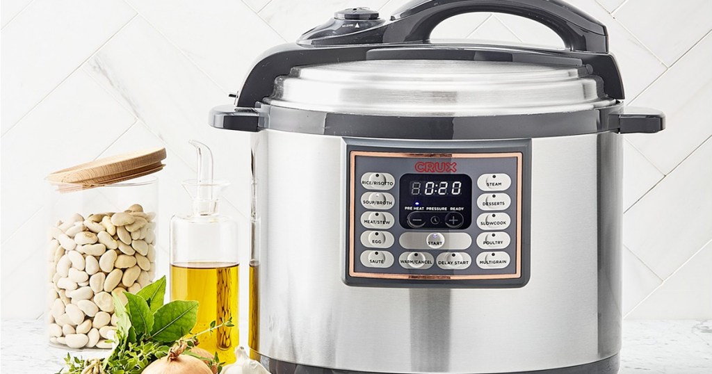 stainless steel and black pressure cooker sitting on kitchen counter