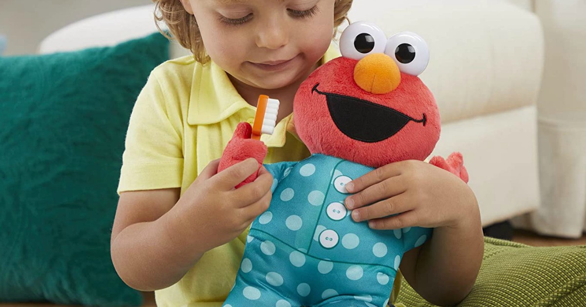 boy playing with an Elmo toy