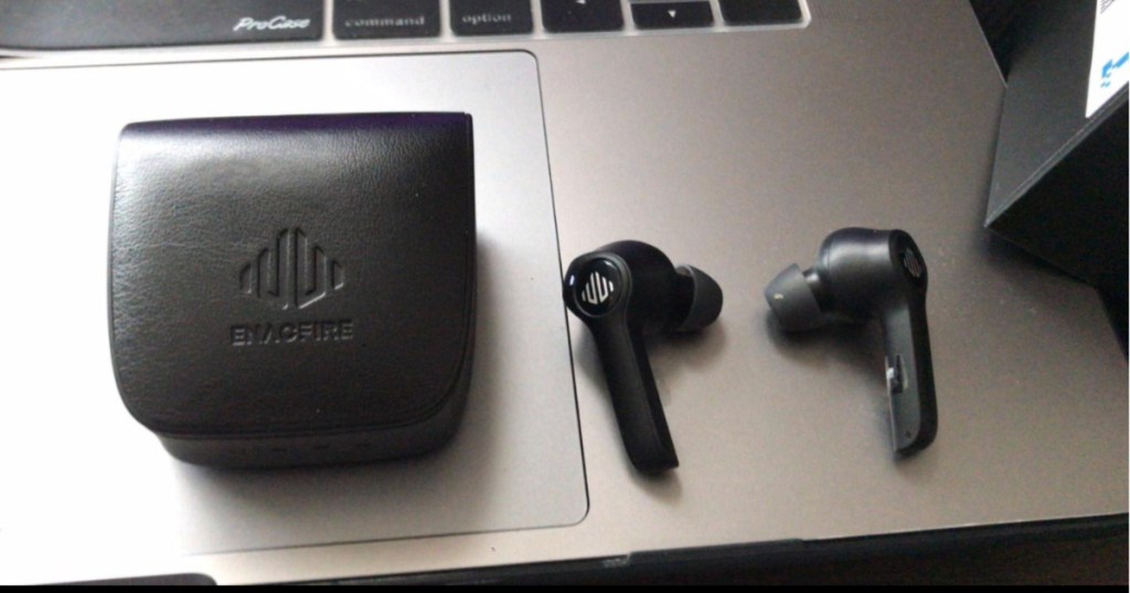 Enacfire Bluetooth Wireless Earbuds out of case with case sitting on laptop