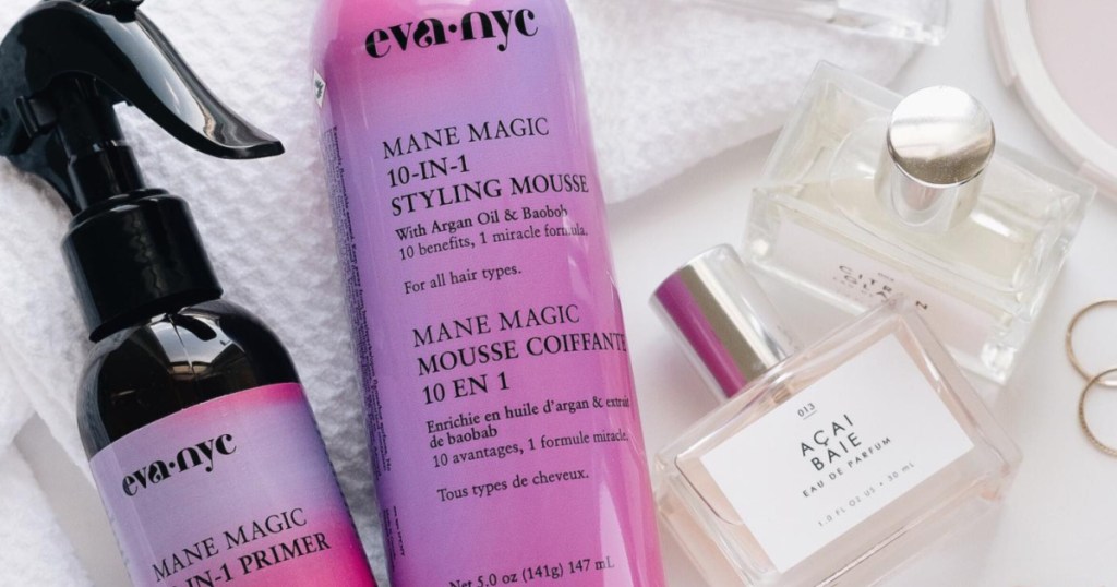 Eva NYC Mane Magic Spray and Mousse laying next to perfume bottle