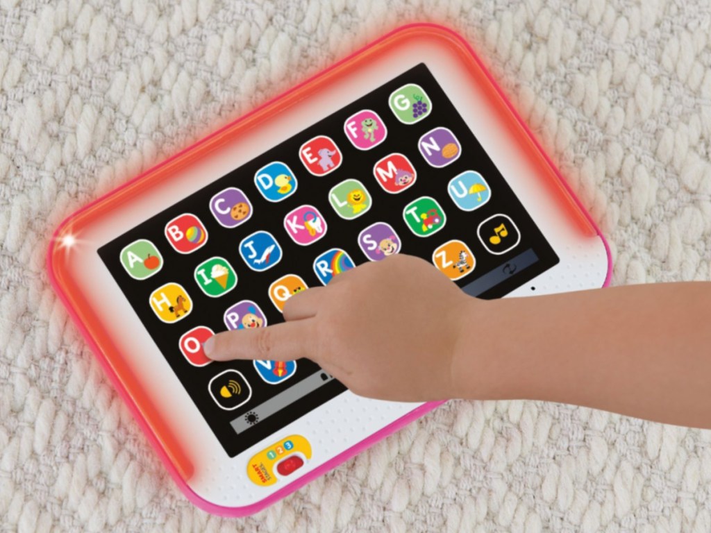 child using red learning tablet