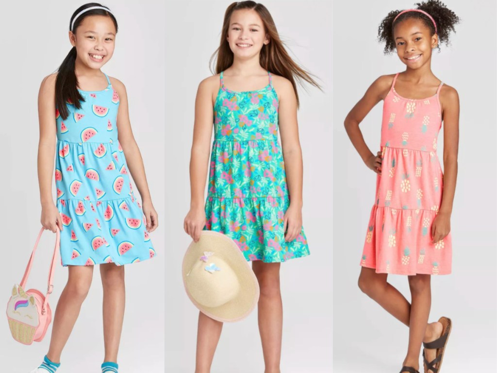 three girls wearing dresses from target, one pink with pineapples, light blue with watermelons, and teal with butterflies