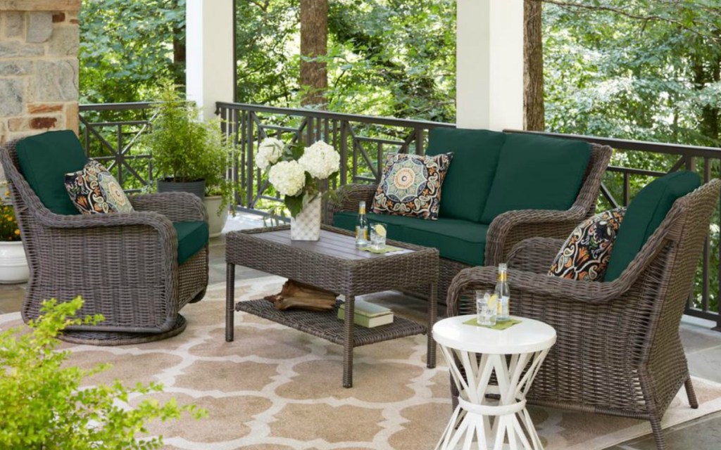 green cushions with a wicker patio set on a patio