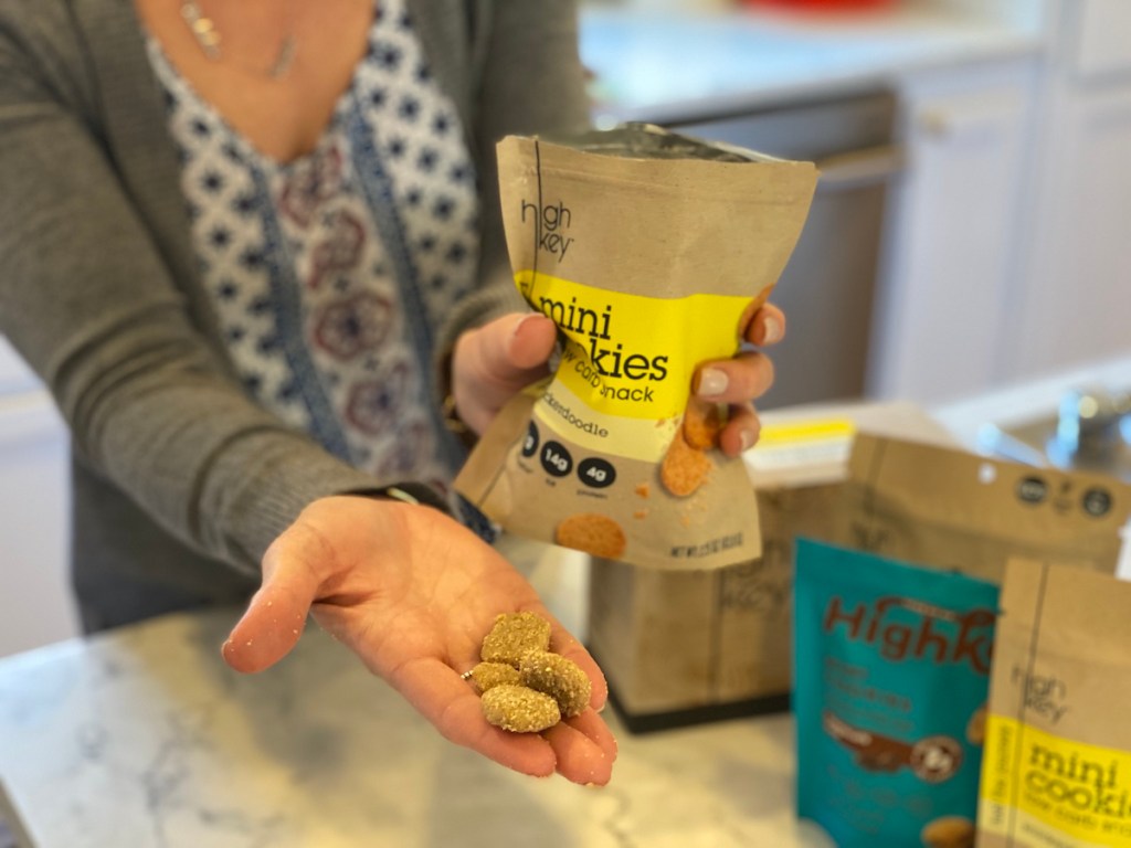 person holding cookies in their hand