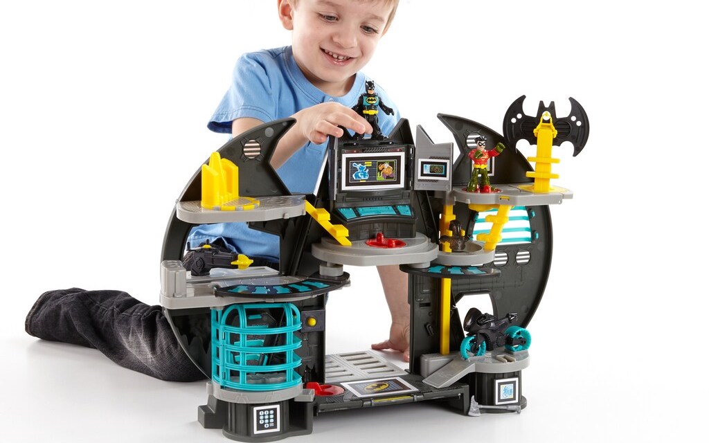 boy playing with a Batman toy