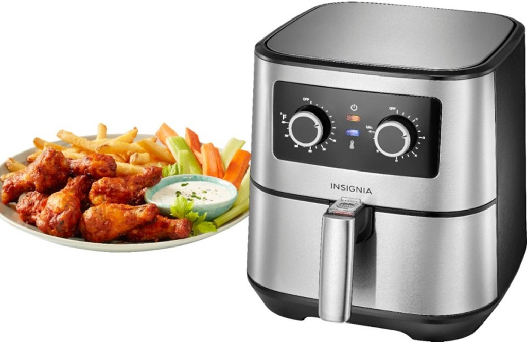 stainless steel and black air fryer with two adjustment knobs next to a plate of chicken wings