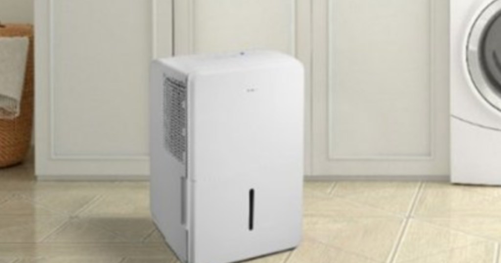 Insignia Dehumidifier sitting the floor in a laundry room