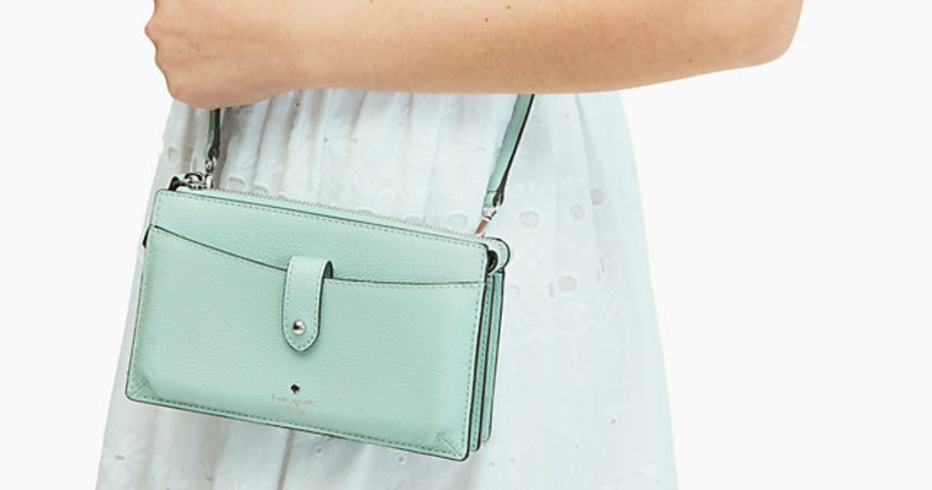 woman holding small mint-colored purse