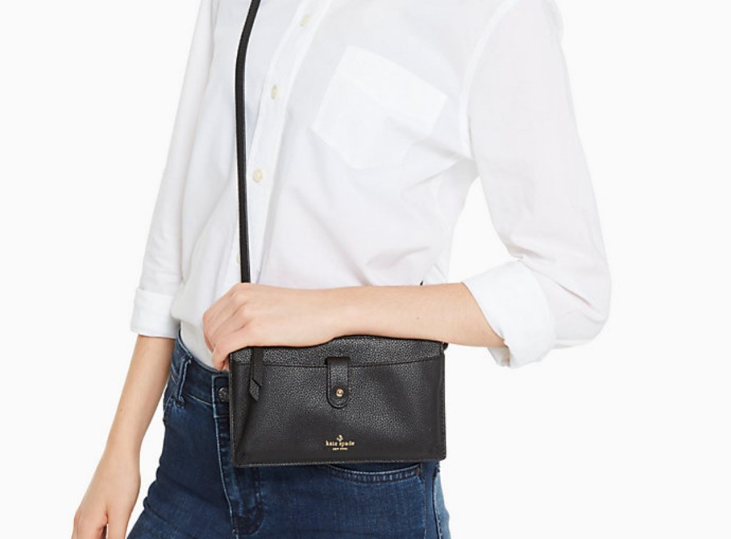 woman holding small black purse