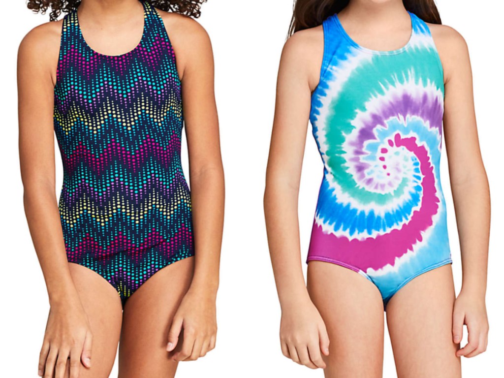 girl in multi-colored dark one-piece swimsuit and girl in tie-dye one-piece swimsuit