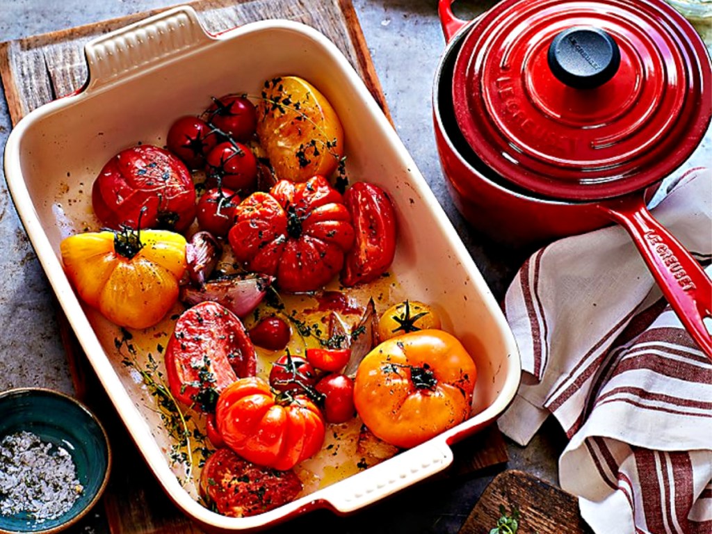 roasted veggies in a baking dish and sauce pot with lid