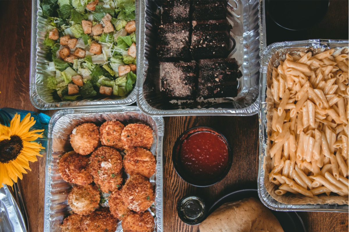 various trays of food on table