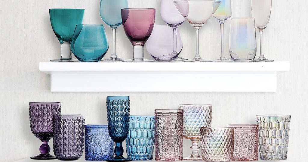 floating shelves on wall filled with various colors of different glassware