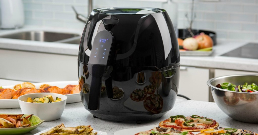 air fryer surrounded by food