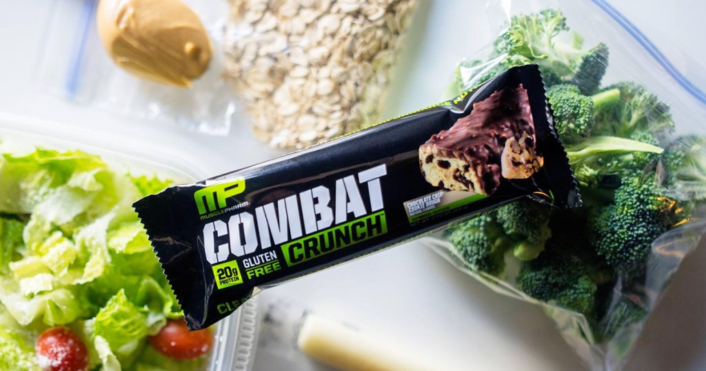 musclepharm protein bar sitting on top of bowl of salad and broccoli 