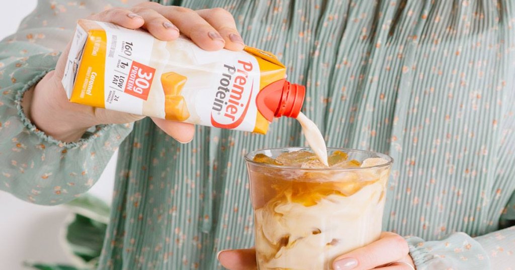 woman pouring caramel premier protein shake into coffee