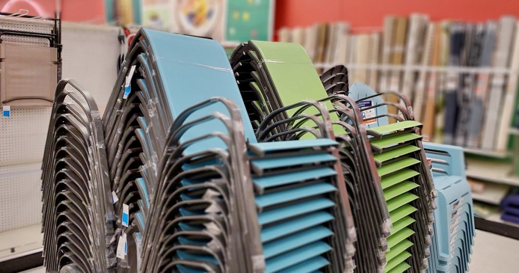 stacks of blue and green patio chairs in store