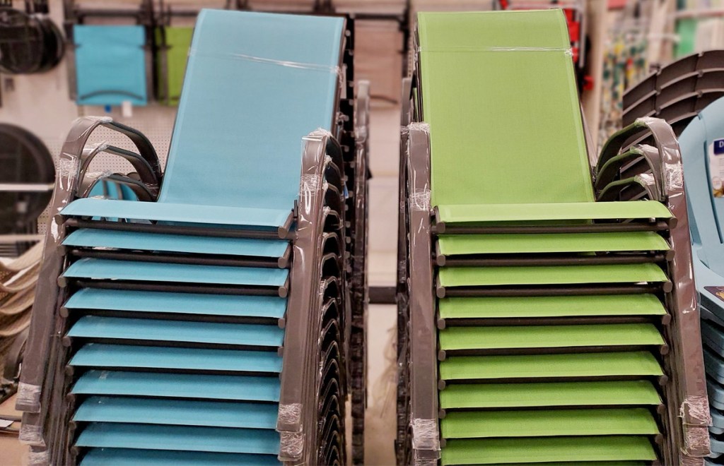 stacks of blue and green patio chairs in store