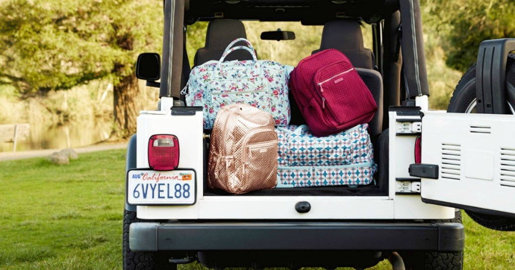 bags and backpacks in the back of a jeep