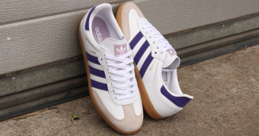 white, tan, and purple shoes leaned against wall outside