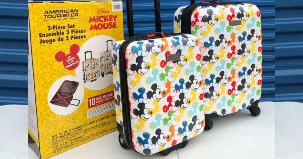 american tourister mickey mouse luggage set in front of blue door