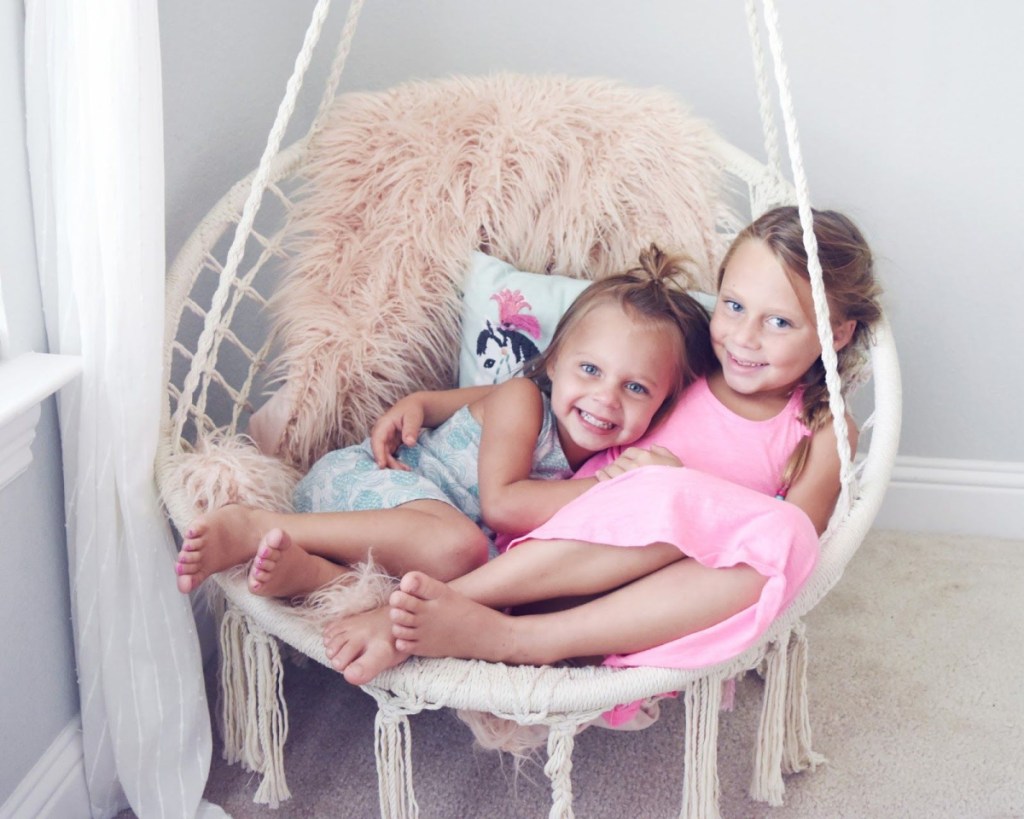 boho hanging chair for kids with two girls in it