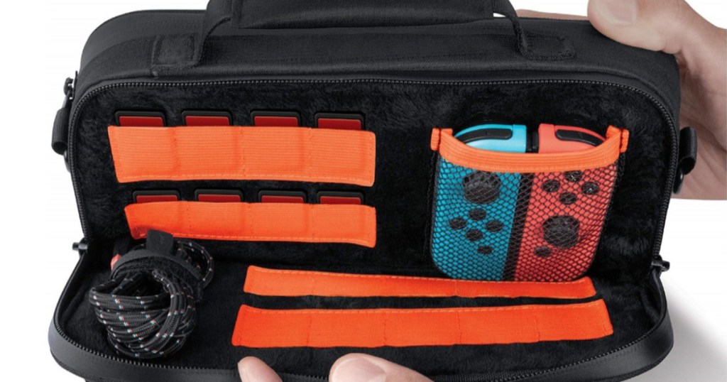 hands holding open handheld gaming console case with accessories inside