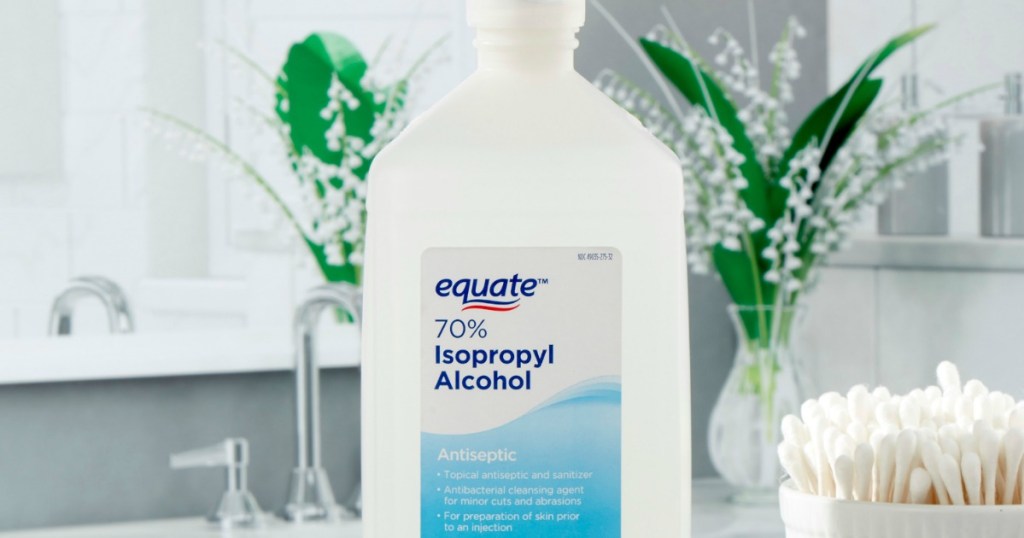 bottle of equate isopropyl alcohol next to container of q-tips