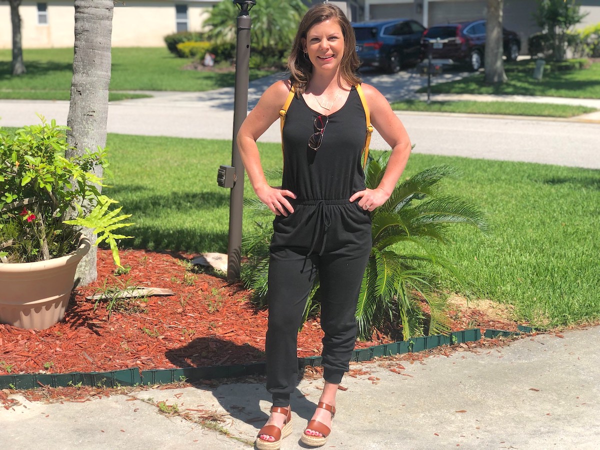 Woman standing outside with hands on hips wearing a black jumpsuit for women