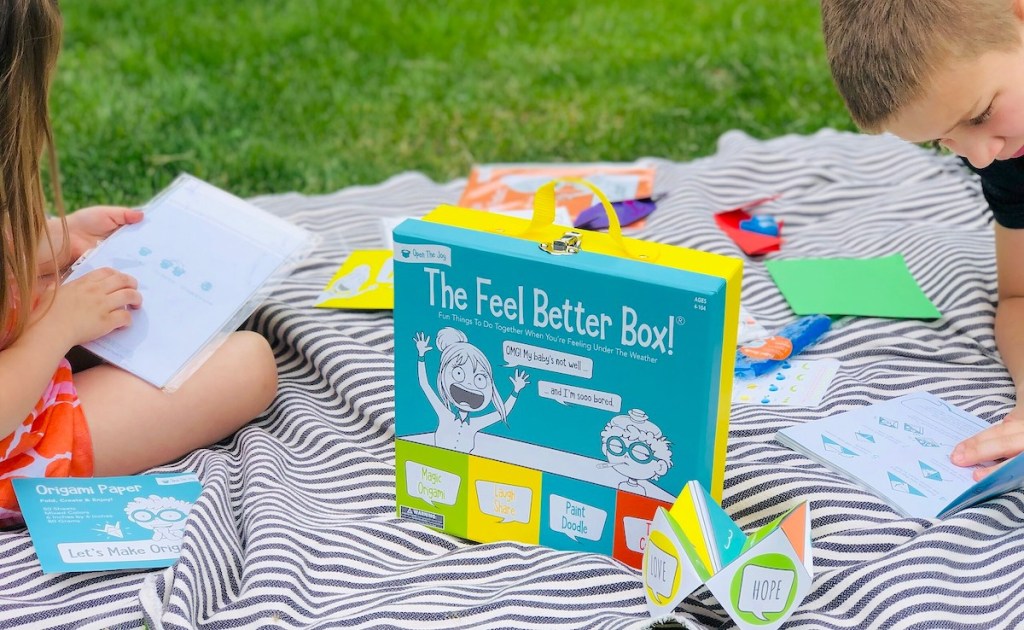 blanket in grass with feel better box and activities 