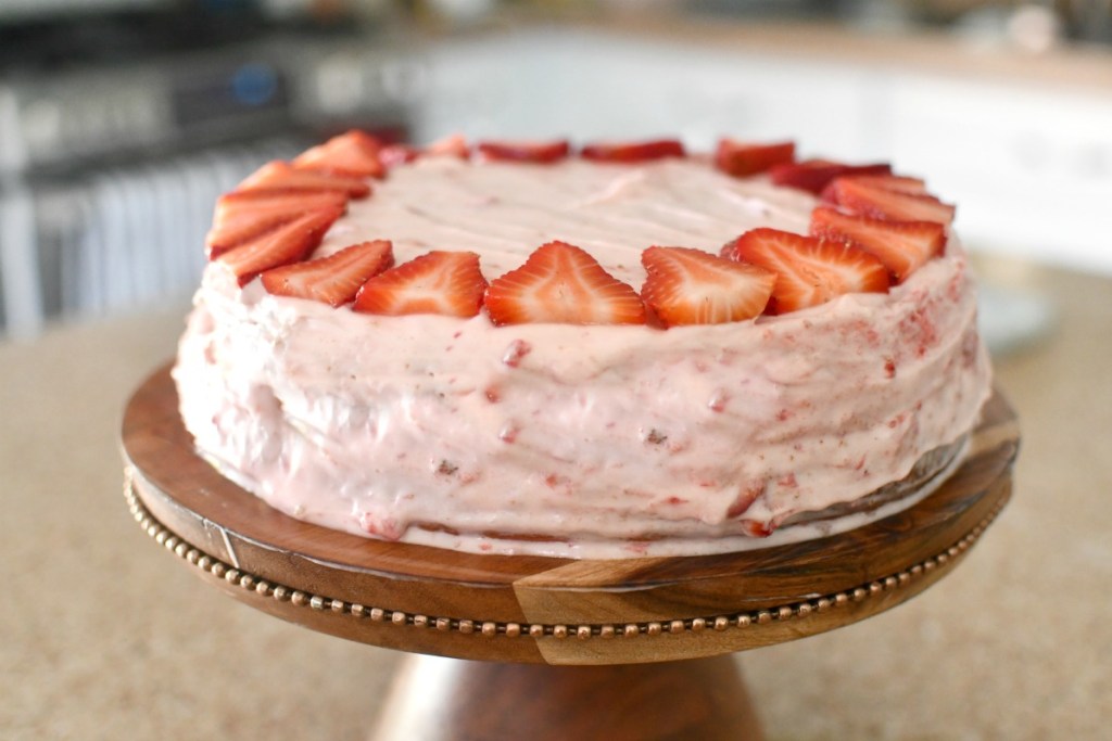 frosted cake with fresh strawberries