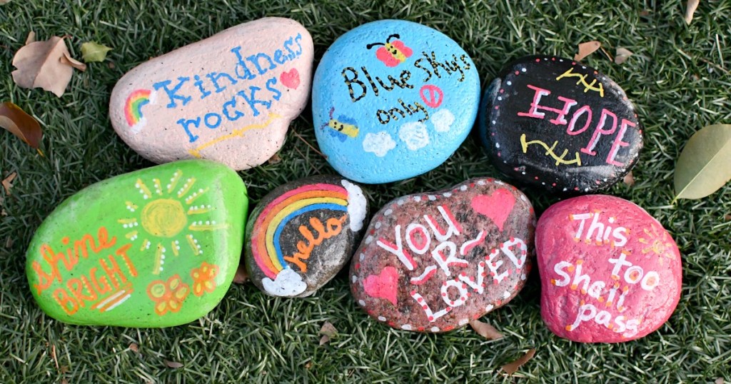 painted kindness rocks on the grass