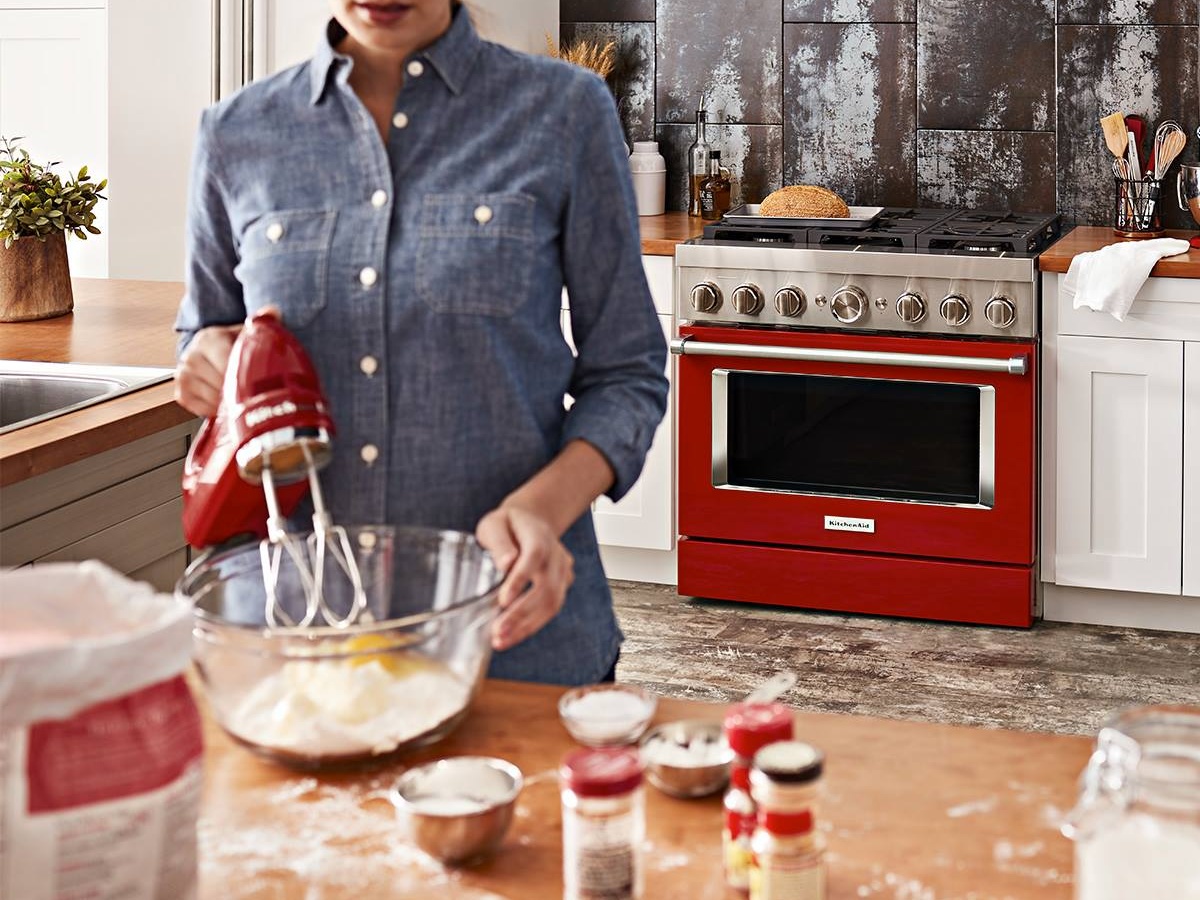 woman baking with red appliances