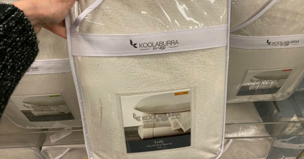 hand holding a package of sheets in a store